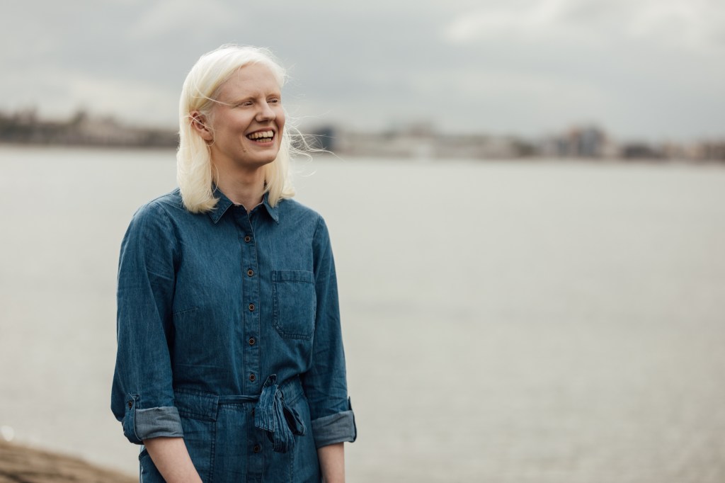 A photograph of Ellen Renton, a white woman with shoulder-length blonde hair.